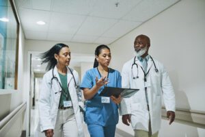 Doctors and nurse discussing medical report.